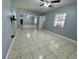 Bedroom featuring tile flooring, mirrored closet doors, a ceiling fan and ensuite bathroom at 2117 W Clifton St, Tampa, FL 33603