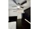 Cozy bedroom with a ceiling fan, dark furniture, and sleek tiled floors at 2117 W Clifton St, Tampa, FL 33603