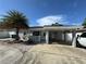 Charming single story home features a carport, palm tree, and an inviting front porch at 2117 W Clifton St, Tampa, FL 33603