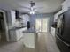 Modern kitchen features stainless steel appliances, tiled backsplash, and large island at 2117 W Clifton St, Tampa, FL 33603