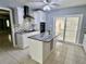 Bright kitchen featuring white cabinets, granite countertops, and stainless steel appliances at 2117 W Clifton St, Tampa, FL 33603