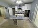 Modern kitchen features a large island with wine rack and stainless steel appliances at 2117 W Clifton St, Tampa, FL 33603