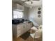 Cozy kitchen featuring white cabinets, a granite countertop, and dining space at 2117 W Clifton St, Tampa, FL 33603