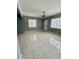 Bright living room featuring neutral tile flooring, a modern chandelier, and lots of natural light at 2117 W Clifton St, Tampa, FL 33603
