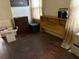 Bedroom with hardwood floors and furniture needing repair and wall needing paint at 2451 Quincy S St, St Petersburg, FL 33711