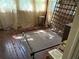 Bedroom with hardwood floors needing refinishing with minimal furniture at 2451 Quincy S St, St Petersburg, FL 33711