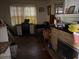 Living room with hardwood floors needing repair and contents scattered on the floor at 2451 Quincy S St, St Petersburg, FL 33711