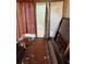 Sun room needing repair with peeling paint, and a box with contents scattered on the floor at 2451 Quincy S St, St Petersburg, FL 33711