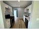 Bright kitchen features modern appliances, white cabinets, and light wood-look flooring at 2465 16Th S Ave, St Petersburg, FL 33712