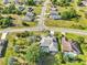 Aerial view of houses in a neighborhood with lush green landscaping, swimming pools, and well-maintained streets at 26180 Deep Creek Blvd, Punta Gorda, FL 33983