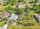 Aerial view of lush green neighborhood with expansive green lawns and mature landscaping at 26180 Deep Creek Blvd, Punta Gorda, FL 33983