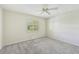 Neutral carpeted bedroom featuring a ceiling fan and a window with shutters at 26180 Deep Creek Blvd, Punta Gorda, FL 33983