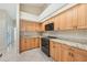 Bright kitchen showcasing light wood cabinetry, black appliances, and neutral counters at 26180 Deep Creek Blvd, Punta Gorda, FL 33983