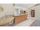 Spacious kitchen features a large island with granite countertops, wood cabinets, and tiled floors at 26180 Deep Creek Blvd, Punta Gorda, FL 33983
