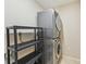 Practical laundry room featuring a stacked washer and dryer unit, and shelving at 26180 Deep Creek Blvd, Punta Gorda, FL 33983