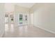 Open-concept living room with French doors leading to the outdoor pool area at 26180 Deep Creek Blvd, Punta Gorda, FL 33983