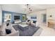 Cozy living room features a large sofa, sitting chairs, and a ceiling fan at 26180 Deep Creek Blvd, Punta Gorda, FL 33983