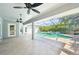 Covered patio area with in-ground pool and spa; a ceiling fan provides air circulation at 26180 Deep Creek Blvd, Punta Gorda, FL 33983