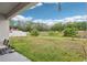 Lawn overlooking the expansive backyard with lush trees and pond in a serene setting at 304 Shell Manor Dr, Ruskin, FL 33570