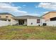 View of the home's exterior featuring a covered patio and spacious backyard at 304 Shell Manor Dr, Ruskin, FL 33570