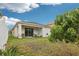 The yard features a patio area and lush green space, ideal for outdoor enjoyment and relaxation at 304 Shell Manor Dr, Ruskin, FL 33570