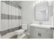This bathroom includes a decorative shower curtain and is adorned with laminate floors at 304 Shell Manor Dr, Ruskin, FL 33570