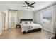 This bedroom features multiple windows, neutral paint and laminated floors at 304 Shell Manor Dr, Ruskin, FL 33570