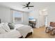 The airy bedroom with laminated floors also includes a flat-screen TV and ensuite bathroom at 304 Shell Manor Dr, Ruskin, FL 33570