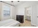 This bedroom includes laminated floors, an electric fireplace, and access to an ensuite bathroom at 304 Shell Manor Dr, Ruskin, FL 33570