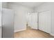 A bright bedroom featuring laminate flooring, white walls, and a closet at 304 Shell Manor Dr, Ruskin, FL 33570