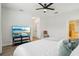 The airy bedroom with laminated floors also includes a flat-screen TV and ensuite bathroom at 304 Shell Manor Dr, Ruskin, FL 33570