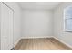 A simple bedroom features laminate flooring, white walls, and a double door closet at 304 Shell Manor Dr, Ruskin, FL 33570