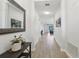 Bright hallway with decorative mirror, table, and an open view to the living area at 304 Shell Manor Dr, Ruskin, FL 33570