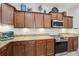 Kitchen features granite countertops, stainless steel appliances, and beautiful wooden cabinets at 304 Shell Manor Dr, Ruskin, FL 33570