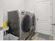 Modern laundry room with front loading washer and dryer and white door at 304 Shell Manor Dr, Ruskin, FL 33570