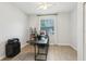 Bright office space with a large window, laminate floors, and modern black furniture at 304 Shell Manor Dr, Ruskin, FL 33570