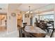 A beautifully staged dining room with water views, and white tile flooring at 31 Island Way # 505, Clearwater Beach, FL 33767