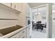A bright kitchen with white cabinetry, view of the dining room, and cook top at 31 Island Way # 505, Clearwater Beach, FL 33767