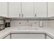 A well-maintained kitchen sink and countertop with matching white cabinetry at 31 Island Way # 505, Clearwater Beach, FL 33767