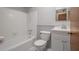 Bright bathroom offers a shower and tub combination, white vanity, and matching toilet at 3212 W Arch St, Tampa, FL 33607