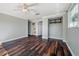 Bright bedroom features stylish wood floors, crown molding, and a view to the attached bathroom at 3212 W Arch St, Tampa, FL 33607