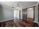 Bedroom with hardwood floors and a wooden barn door accessing a closet at 3212 W Arch St, Tampa, FL 33607