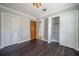 Cozy bedroom with hardwood floors features dual closets and an access door to the en suite bathroom at 3212 W Arch St, Tampa, FL 33607