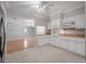 Bright kitchen featuring white cabinets, modern appliances, and an open design into the nearby dining area at 3212 W Arch St, Tampa, FL 33607