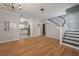 Spacious living room with hardwood floors, staircase, and views into the kitchen at 3212 W Arch St, Tampa, FL 33607