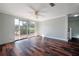 Bright living room features hardwood floors, a sliding glass door to the deck, and staircase access at 3212 W Arch St, Tampa, FL 33607