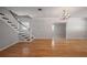 Inviting living room with hardwood floors, a decorative chandelier, and staircase access to the second floor at 3212 W Arch St, Tampa, FL 33607