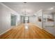 Open concept living room featuring beautiful hardwood floors, a chandelier, and easy access to the kitchen at 3212 W Arch St, Tampa, FL 33607