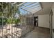Covered patio with iron work features and adjacent garage and access to rear of house at 3212 W Arch St, Tampa, FL 33607