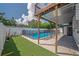 Backyard with artificial turf, and a refreshing pool with protective safety fence at 3212 W Arch St, Tampa, FL 33607